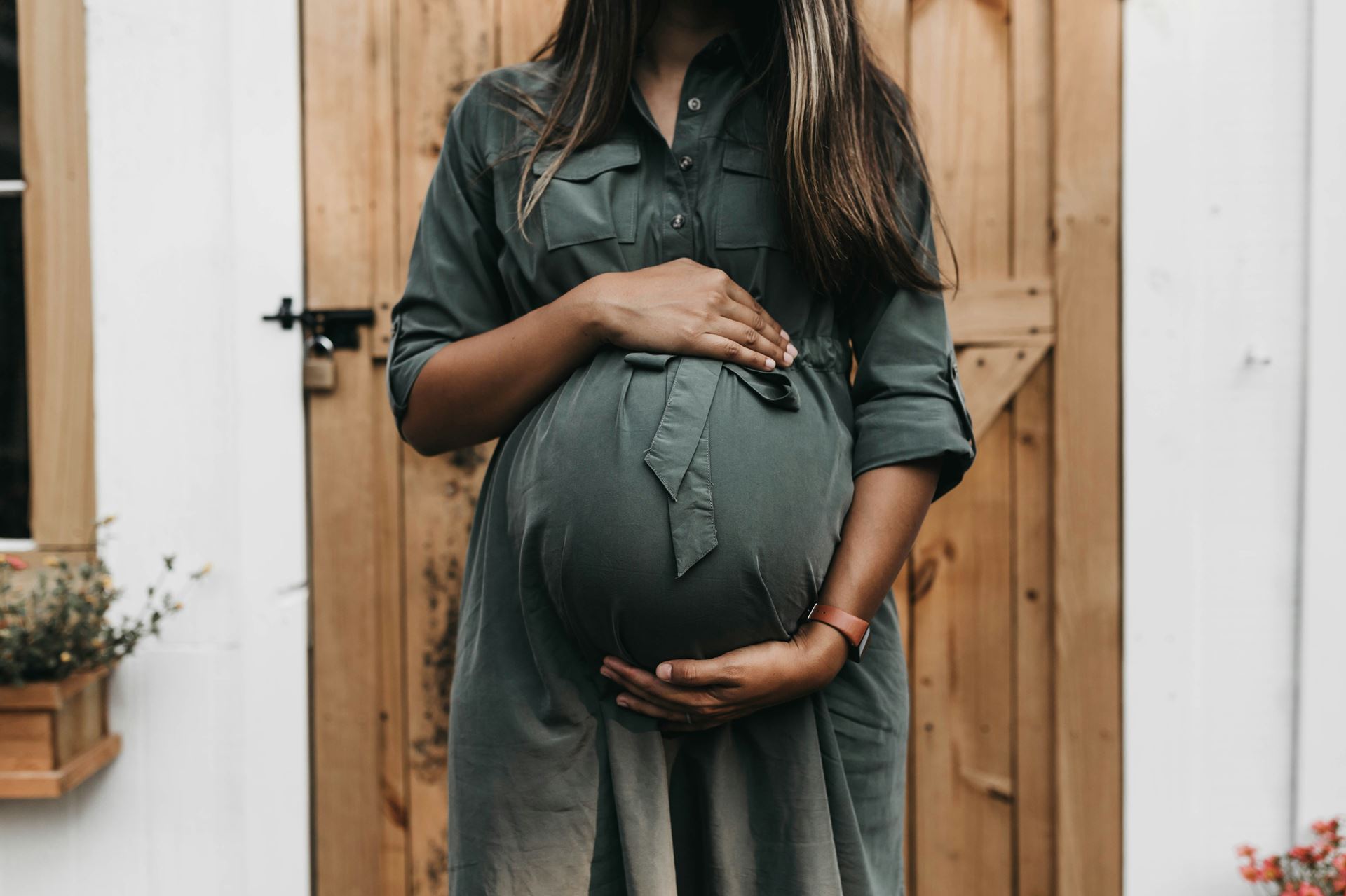 a pregnant woman holding her baby bump