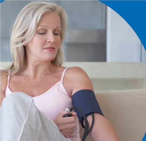 a woman measureing her blood pressure at home