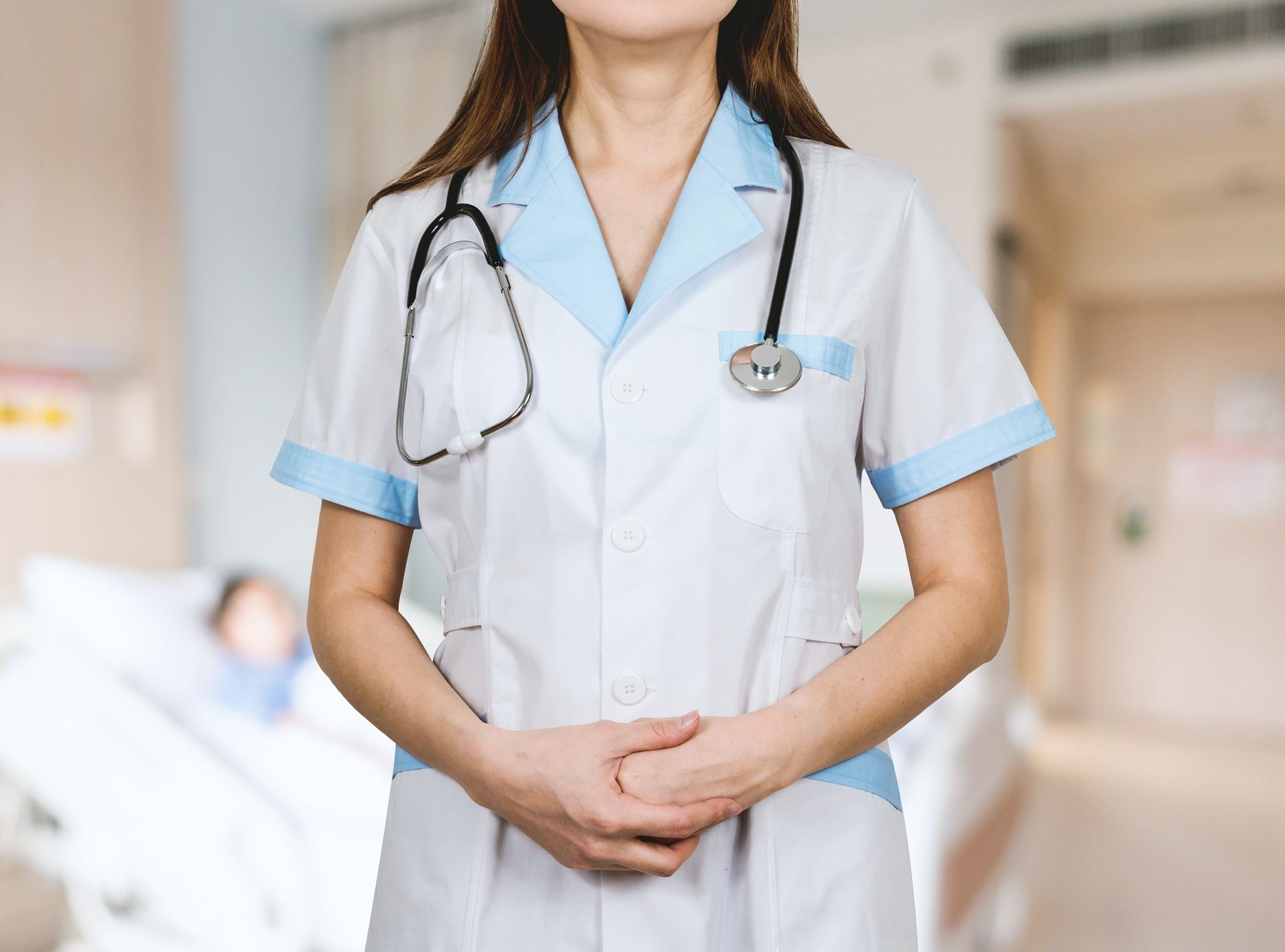a health care professional with a stethoscope over her shoulders 