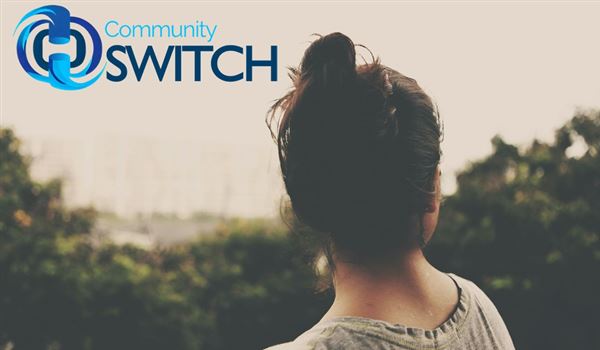 a woman with her back to the camera looking into the distance and the Community SWITCH logo